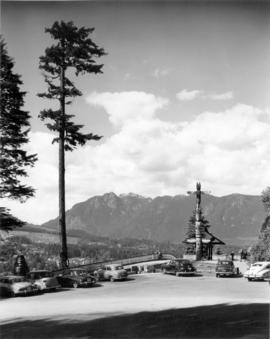 [Prospect Point showing totem pole, automobiles, mountains and north shore in the distance]