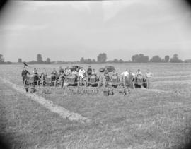 [Men on tractors lined up in a field]