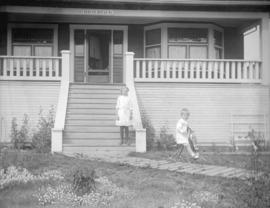 [Jean and Jack Davidson in front of "Braeriach" at 2119 West 42nd Avenue]