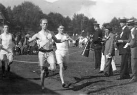 [Three men crossing the finish line after a race]