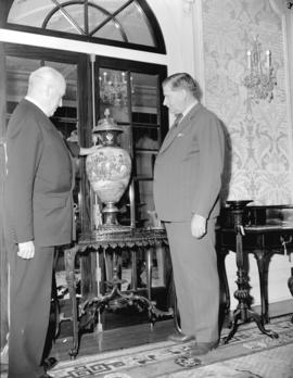 Honourable Ian McKenzie and General McRae [inspecting an urn at Hycroft]