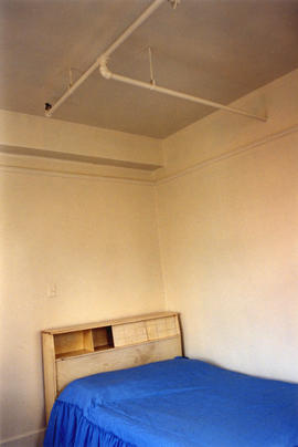 Bed inside Columbia Hotel at 303 Columbia Street