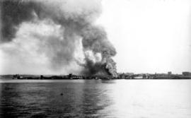 [View across the water of a fire at a North Vancouver dock]