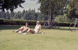 Unidentified man and woman sunbathing