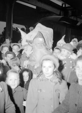 [Children with Santa Claus at a Christmas party]