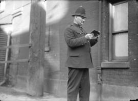 [Police constable standing in Market Lane near City Hall]