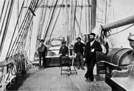 Men standing on deck of a sailing ship
