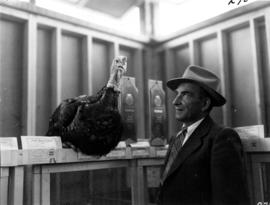 Man with award-winning turkey in 1955 P.N.E. Poultry and Pet Stock competition