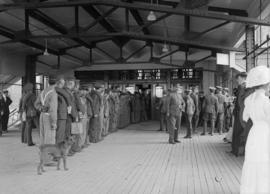 Military men waiting in line on a platform