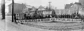 [Y.M.C.A. banner being held across Burrard Street in front of Wesley Methodist Church]