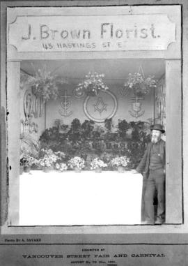 'J. Brown Florist' booth at Vancouver street fair and carnival, with Joseph Brown at right