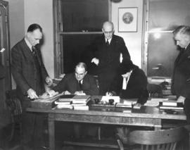 [Major and Mrs. J.S. Matthews sign documents to appoint responsibility for the Archives' holdings...