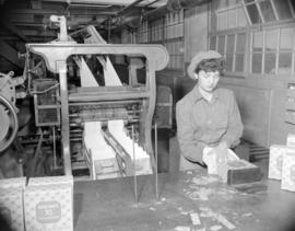 [Woman packaging paper napkins at Westminster Paper]