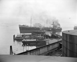 [The 'A.C. Rubel' tanker and other boats docked at the B.A. Oil Company refinery up Burrard Inlet]