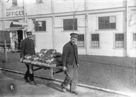 29th Battalion and Yukon Detachment [two soldiers carrying rack piled with bread]