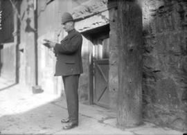 [Police constable standing in Market Lane near City Hall]