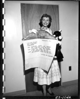 Colleen Black, contestant in Miss P.N.E. 1957, with telegram from citizens of Kamloops