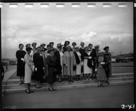 Women on P.N.E. grounds, with Livestock building in background