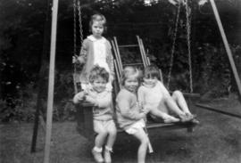 [John Banfield, Jane Banfield, Alix Louise Gordon, and boy] playing in the back yard