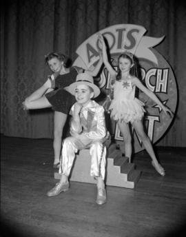 [Group of children in costumes posed in front of an AOTS "Search for Talent" sign]