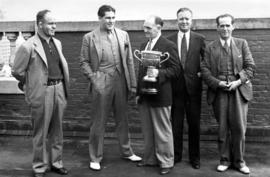 Group of men witnessing trophy presentation, includes George Fitch