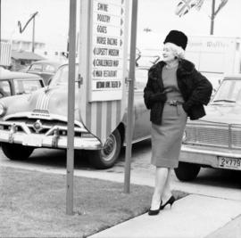 Woman next to directional sign on P.N.E. grounds