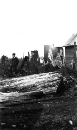 Man standing on burned area at 985 West 23rd Ave