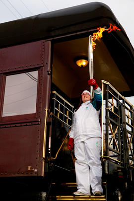 Day 90 Torchbearer 9 Kaitlyn Baskerville carries her flame off of a CP Rail train in Canoe, Briti...