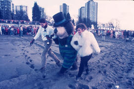 Tillicum walking on beach with man and woman at Polar Bear Swim