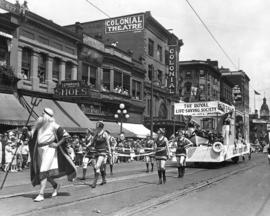 [King Neptune and the "Jantzen Girls" in swim suits pulling a Royal Life Saving float i...