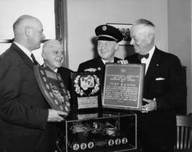 [Chief H.S. Bird receiving plaques awarded for outstanding work on Fire Prevention Week]