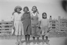 Four young women standing on road