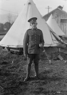 [Soldier in front of a tent]