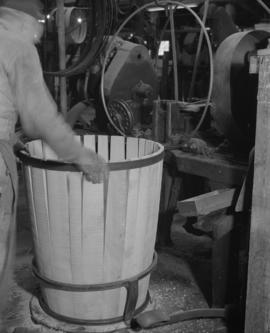 Stave pieces being shaped into a barrel