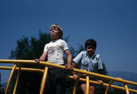 [Two boys on playground equipment]