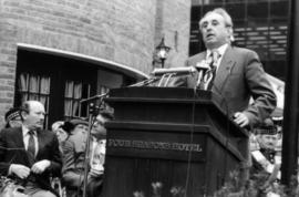 Unidentified man speaking from podium