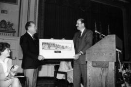 Mike Harcourt presents framed print to unidentified man