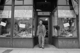 Owner Lin Bei-lian in front of Wing Hing Dry Goods Ltd., unit block  East Pender Street, on the e...