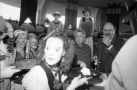 Woman in clown costume serving cake