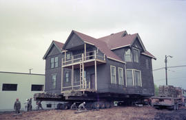 [Rear view of Hodson House raised on wheels during house relocation, 2 of 3]