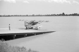 [A float plane going into the water from a ramp]