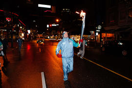 Torchbearer 151 Benoit Huot carries the flame in Vancouver, BC