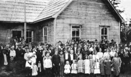 [People gathered in front of the Community Hall for a fair]