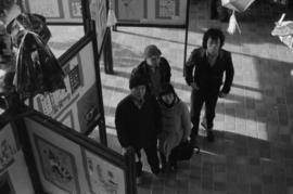 People looking at a historical photographs exhibit at the Chinese Cultural Centre Spring Festival