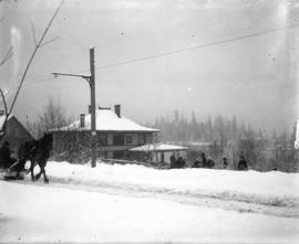 [Horse drawn sleigh on street, and people assembled outside 1218 Seaton Street (Hastings Street),...