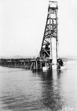 Close-up of pile driver putting in pier : April 7, 1924