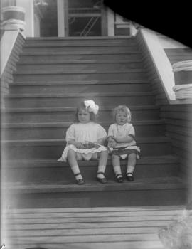 Two of the Salter girls sitting on stairs of house