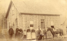 [Group portrait in front of Thomas William Fletcher's cottage]