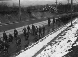 Military parade with marching band on a road