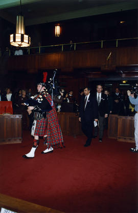 Bagpiper entering council chambers at International Day to End Racial Discrimination ceremony